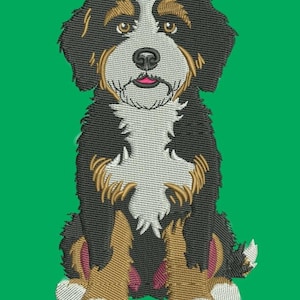 May include: Embroidered image of a Bernese Mountain Dog puppy, featuring a black, white, and tan color scheme. The dog is sitting with its tongue slightly out, set against a solid green background. The embroidery details the dog's fur.
