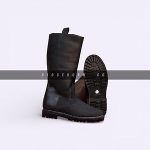 May include: Black leather boots with a textured sole and a pull tab at the top. The boots have a matte finish and a sturdy design. The brand name "RIDGEBORN CO" is printed on the image.