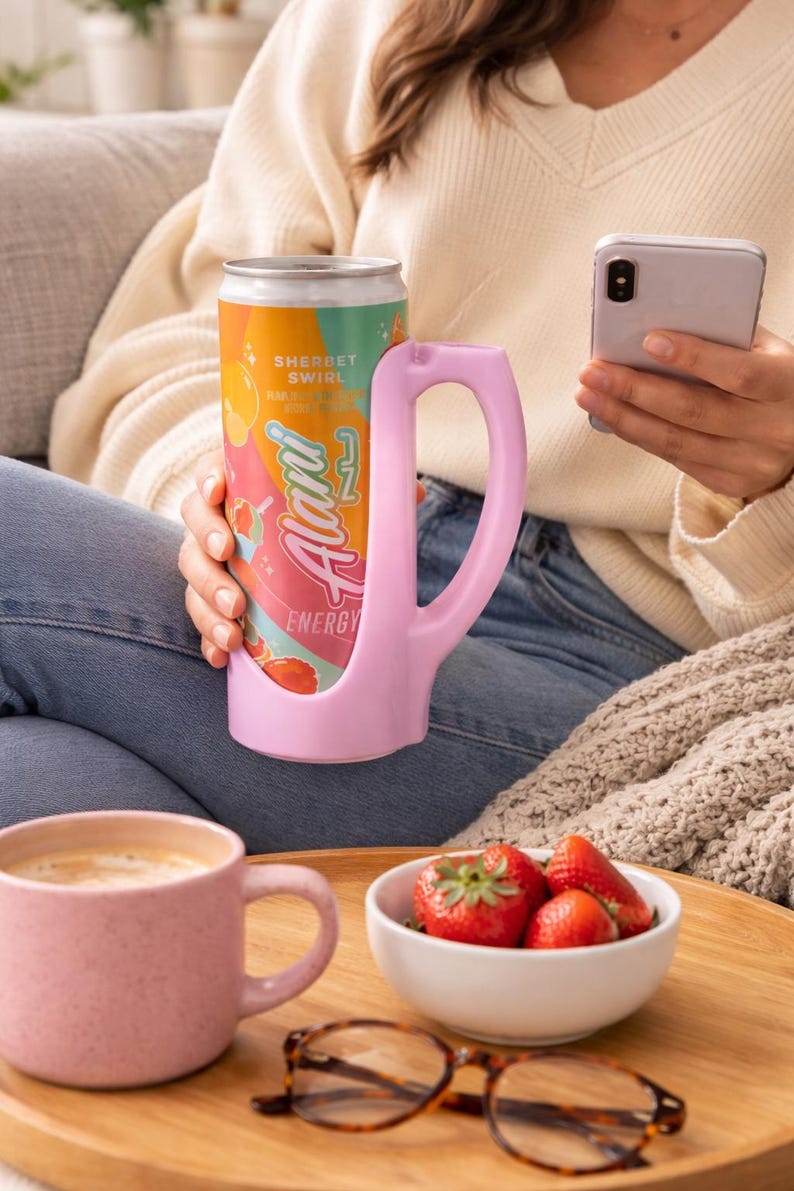 May include: A white ceramic mug with a black handle and the text "But First, Coffee" in a handwritten style. The mug is on a white surface. The mug is approximately 4 inches tall.