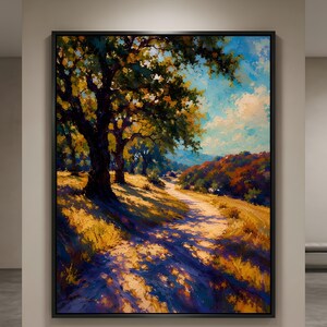 May include: A framed landscape painting depicting a winding dirt path through a golden field with large, dark-trunked trees casting deep blue shadows. The scene features vibrant autumn foliage in the distance under a bright blue sky with clouds.