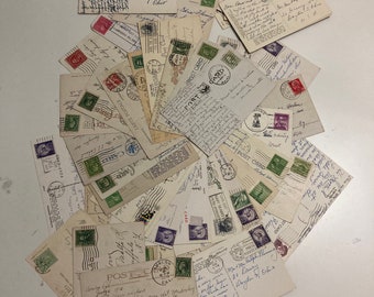 May include: A collection of vintage postcards, many with handwritten messages and postage stamps. The postcards are in various conditions, with some showing signs of age and wear. The stamps are in shades of green, purple, and red.