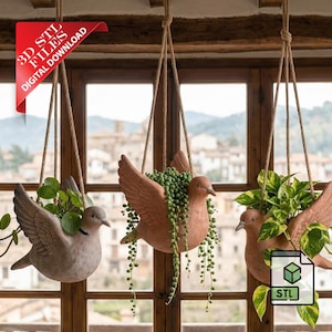 May include: Three hanging bird-shaped planters with plants. The planters are made of terracotta and are suspended by rope. The plants include trailing vines and leafy greens. A red banner in the upper left corner reads "3D STL FILES DIGITAL DOWNLOAD".