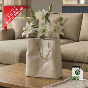 May include: A white ceramic vase shaped like a shopping bag, with a brown rope handle, holds white lilies with green stems and leaves. The vase sits on a wooden coffee table. A red banner reads "3D STL FILES DIGITAL DOWNLOAD."