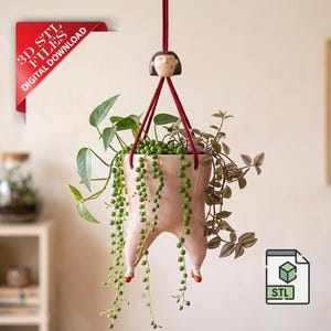May include: A hanging planter with a unique design, featuring a pink pot shaped like legs with red accents. The planter is suspended by a red rope and adorned with trailing green plants. The image also includes a red corner banner with the text "3D STL FILES DIGITAL DOWNLOAD".