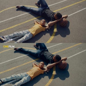 May include: Two people lying on a basketball court, one in a black shirt and jeans, the other in a yellow shirt and gray pants. A basketball rests near the person in black. The text "REC709" and "CINEFILM" are visible.