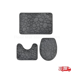 May include: A dark grey three-piece bathroom mat set with a pebble stone design. The set includes a rectangular bath mat, a U-shaped contour mat, and a toilet seat cover. The mats have a soft, textured surface for comfort and style.