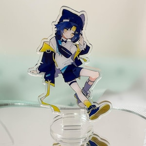 May include: A clear acrylic standee featuring an anime-style character with blue hair, wearing a dark blue cat-ear hat, a white shirt, a dark blue jacket with yellow accents, dark blue shorts, and blue sneakers with yellow soles and yellow socks.
