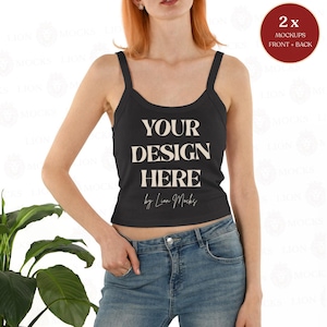 May include: Black tank top with wide straps and the text "YOUR DESIGN HERE" in a bold, serif font. The tank top is paired with blue jeans. A mockup label is in the upper right corner.