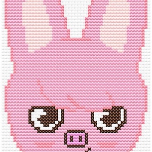 May include: Cross-stitch design of a pink bunny face with large ears, brown eyes, and a small pink nose. The design is created with a grid of stitches, giving it a pixelated appearance. The bunny face is centered on a white background.