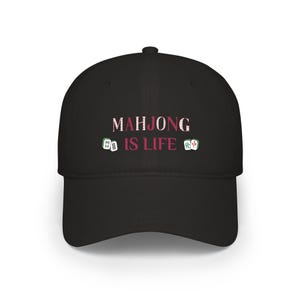 May include: Black baseball cap with the text "MAHJONG IS LIFE" in pink and white lettering. The cap features small Mahjong tile graphics on either side of the text. A stylish accessory for Mahjong enthusiasts.