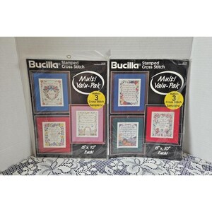 May include: Two Bucilla Stamped Cross Stitch Multi Valu-Pak kits, each containing materials to make 3 samplers. The packaging features black backgrounds with white text and yellow circles stating 3 samplers, with 20.32 cm by 25.4 cm dimensions.