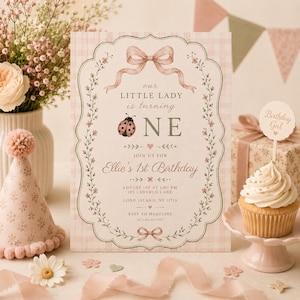 May include: A first birthday invitation with a pink and white checked background. The invitation has a ladybug illustration and the text "Our Little Lady is turning ONE." A cupcake with a "Birthday Girl" sign is also present.