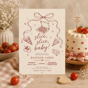 May include: A rectangular baby shower invitation card on cream paper with dark red line art featuring a pizza box, pizza slices, tomatoes, and a bow. The text reads: slice, slice, baby! Please join us for a baby shower honouring Madison James, Saturday 21 June 2025, 2:00 PM, The Pizzeria, 123 Marinara Way, Naples, FL 34102.