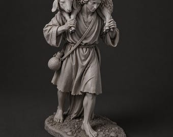 Estatua de un pastor con ovejas en un belén
