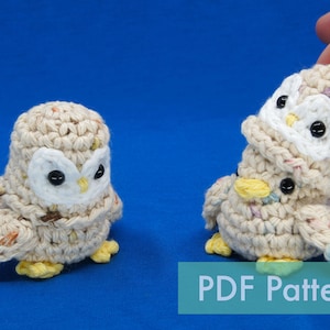 May include: Two crocheted owl amigurumi toys with white and yellow accents. The owls are beige with black eyes and are sitting on a blue surface. The text "PDF Pattern" is visible at the bottom of the image.