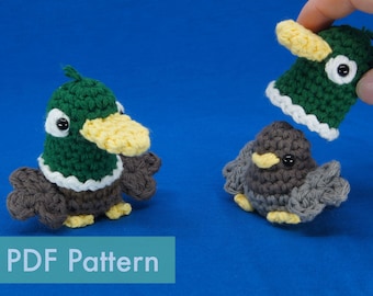 May include: A crochet pattern for making a duck and a bird. The duck is green with a yellow beak and white trim. The bird is grey with a yellow beak. The pattern is available as a PDF download.