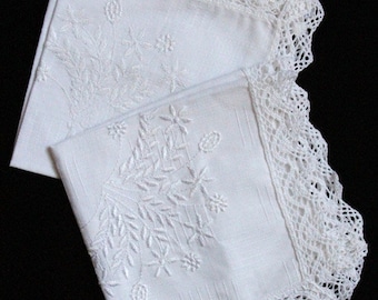 May include: Two white linen handkerchiefs with delicate floral embroidery and a crocheted lace border.