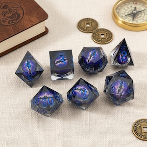 May include: Set of seven polyhedral dice with a fantasy theme. The dice are clear with a purple and blue design, featuring numbers in blue. A compass, coins, and a leather-bound book are also in the image.