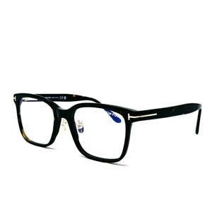 May include: Black rectangular eyeglasses with a tortoiseshell pattern on the inner frame. The glasses have a silver accent on the temples and clear lenses. The frames are set against a white background.