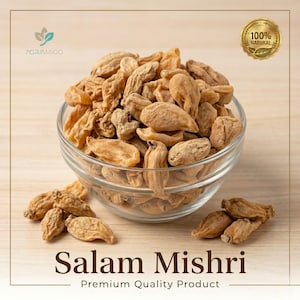 May include: A clear glass bowl filled with dried Salam Mishri, a premium quality product. The dried pieces are light brown and oval-shaped. The image includes a gold seal that says "100% Natural".