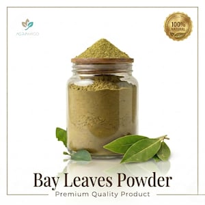 May include: A glass jar filled with green bay leaves powder, topped with a wooden lid. Fresh bay leaves are arranged near the jar. The text "Bay Leaves Powder" and "Premium Quality Product" are displayed below the jar.