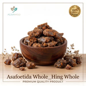 May include: A wooden bowl filled with asafoetida, a brown, resinous spice, with pieces scattered around it. The text "Asafoetida Whole_Hing Whole" and "Premium Quality Product" are at the bottom. A "100% Natural" seal is visible.