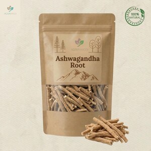 May include: A brown paper bag with a clear window displaying ashwagandha root sticks. The label reads "Ashwagandha Root" with a mountain illustration. A small pile of the root sticks sits in front of the bag. A green circular stamp reads "100% Natural".