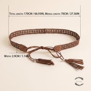 May include: A brown belt featuring a woven lattice pattern, a tie-front closure with long cords, and two tassels at the ends. The belt has a total length of 66.93 inches, a middle length of 27.56 inches, and a width of 1.14 inches as indicated.