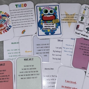 May include: A selection of rounded-corner cards with illustrations and text. Some cards feature characters from the movie "Inside Out", while others have phrases like "It's ok to feel..." and "I am loved.".