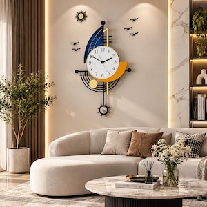 May include: A wall clock shaped like a sailboat with a white circular face, black numerals, and black hands. The clock features a blue sail, a yellow hull, a sun icon, and black bird silhouettes. A black pendulum with a circular weight hangs below.
