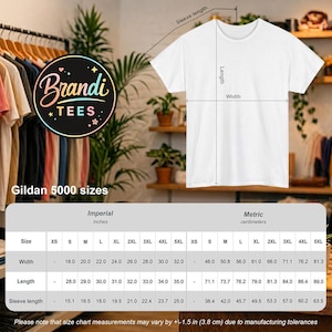 May include: A white t-shirt with a size chart displaying width, length, and sleeve length measurements in inches for Gildan 5000 sizes ranging from XS to 5XL. The chart includes imperial measurements for each size, providing a clear guide for selection.