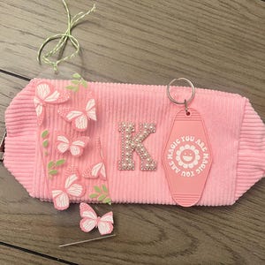 May include: A handmade, wooden cutting board with a natural finish. The board features a live edge on one side and a smooth, rectangular shape. It is approximately 18 inches long and 12 inches wide.