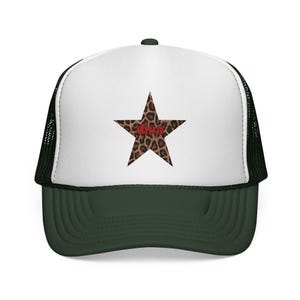 May include: A dark green and white trucker hat. The front panel is white, with a leopard print star and the red word "diva". The back is mesh.