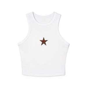 May include: White crop top with a scoop neck and a star design. The star is filled with a brown and tan leopard print pattern. The top is made of a soft, lightweight material.