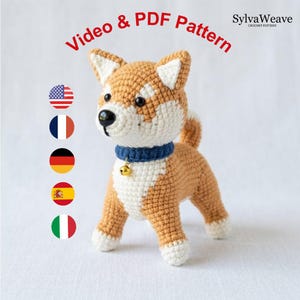May include: A crochet dog toy with tan and white yarn, featuring a blue collar with a small gold bell. The text Video & PDF Pattern and SylvaWeave Crochet Pattern appear above the figure, alongside five circular national flag icons.