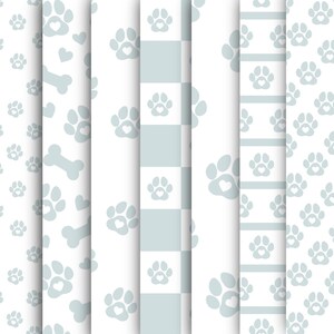 May include: A collection of seamless patterns featuring light blue paw prints with heart-shaped centers, bones, and hearts on a white background. The patterns include a checkerboard design and striped borders, perfect for pet-themed crafts and designs.
