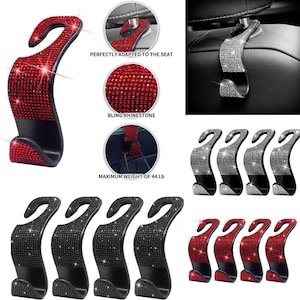May include: Car seat headrest hooks with a curved design. The hooks are embellished with rhinestones in red, black, and silver. The image shows close-ups of the rhinestone detail and the hook's attachment to a car seat.