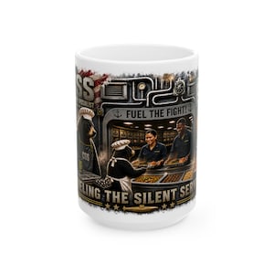May include: A white ceramic mug featuring a graphic illustration of two bears in chef hats and aprons serving food to two people in a submarine galley. The text reads FUEL THE FIGHT and FEEDING THE SILENT SERVICE with an American flag background.