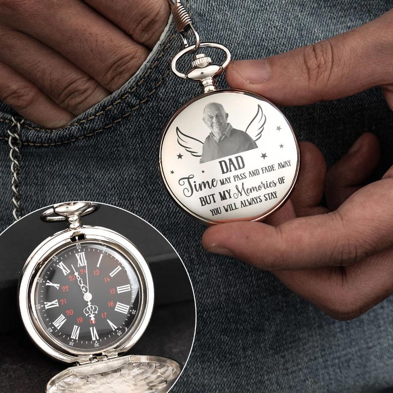 May include: Silver pocket watch with a black face and white Roman numerals. The watch has a chain and is open to reveal the time. The watch face has the text "DAD Time may pass and fade away but my memories of you will always stay."