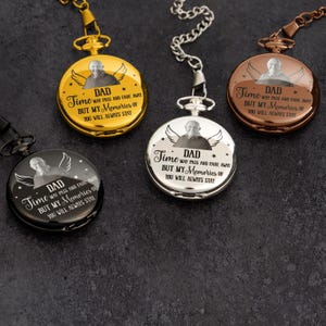 May include: Four pocket watches with chains are displayed. The watches are gold, silver, bronze, and black. Each watch has a picture of a man with angel wings and the text "DAD Time may pass and fade away but my memories of you will always stay."