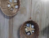 Set of two star fish and sea shell in a wicker basket