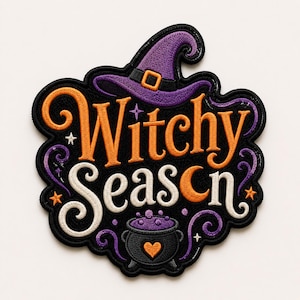 May include: An embroidered patch with a black background featuring the text Witchy Season in orange and white script. The design includes a purple witch hat, a black cauldron with purple bubbles and an orange heart, and small orange stars.
