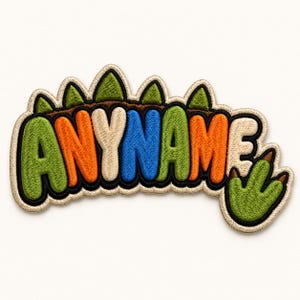 May include: Embroidered patch with the text "ANYNAME" in a colorful, bubble-style font. The patch features a green dinosaur claw and a brown and green design above the text, all outlined in black.
