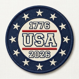 May include: Embroidered patch with a circular design featuring a navy blue border with white stars. The center circle is cream-colored with the text "1776 USA 2026" in a bold, patriotic font, separated by red lines. The patch is likely for apparel or accessories.