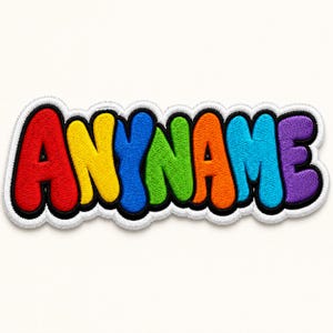 May include: Embroidered patch with the text "ANYNAME" in a bubble letter style. The letters are in a rainbow of colors: red, yellow, blue, green, orange, and purple, outlined in black. The patch has a white border with a black outline.