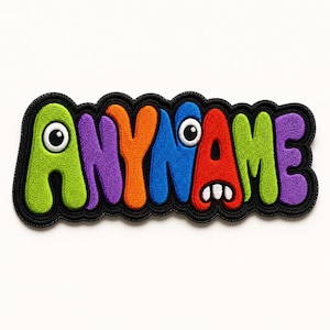 May include: A colorful embroidered patch with the word "ANYNAME" in a playful, cartoonish font. The letters are in green, purple, orange, blue, red, and green, each with a cartoon eye or mouth. The patch has a black border.