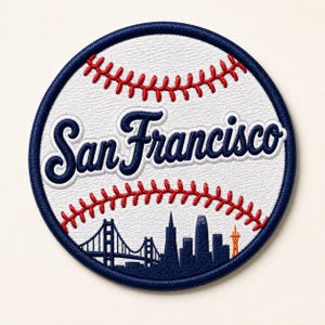 May include: Embroidered patch in the shape of a baseball, featuring the text "San Francisco" in navy blue script. The design includes a navy blue skyline of San Francisco and the Golden Gate Bridge, with red stitching details.