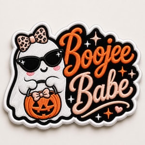 May include: An embroidered patch featuring a white ghost wearing black sunglasses and a leopard print bow, holding an orange jack-o'-lantern bucket. The text Boojee Babe is stitched in orange and light pink on a black background with stars.