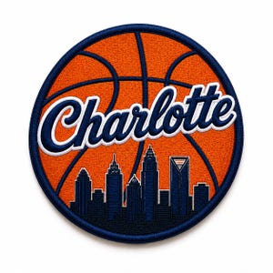 May include: A round patch featuring a basketball design with the word "Charlotte" in white script. The patch includes a blue skyline silhouette and is bordered by a blue stitched edge. The basketball is orange with dark blue lines.