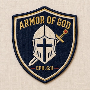 May include: A shield-shaped embroidered patch with a dark blue background and gold border. It features a white knight helmet with a dark blue cross, a sword with a red pommel, and the gold text ARMOR OF GOD above and EPH. 6:11 below the helmet.